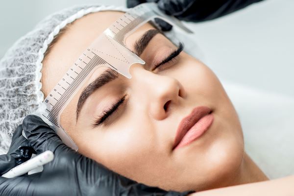 Girl getting brows mapped for her combination brows treatment